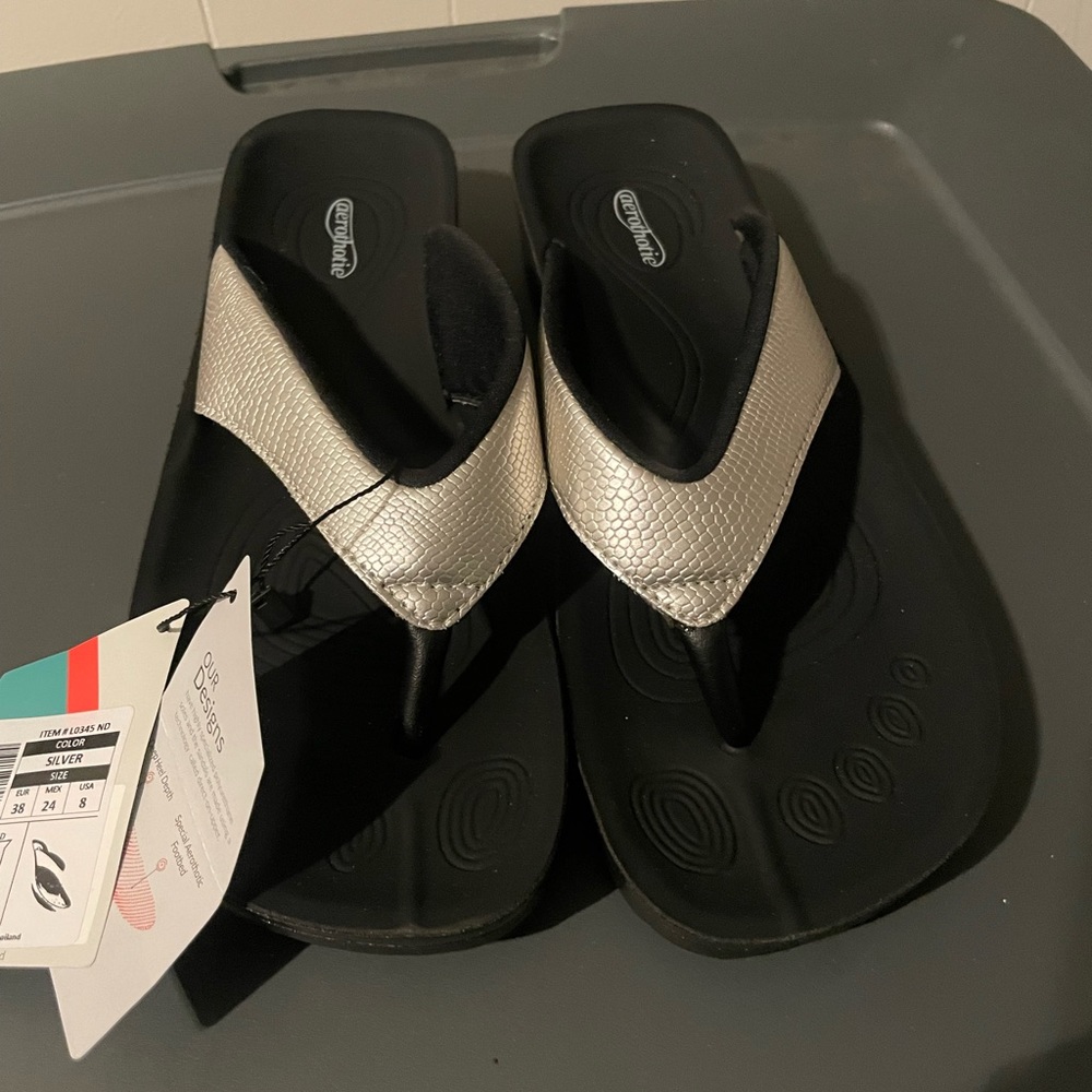 Never worn aerothotic silver flip flops